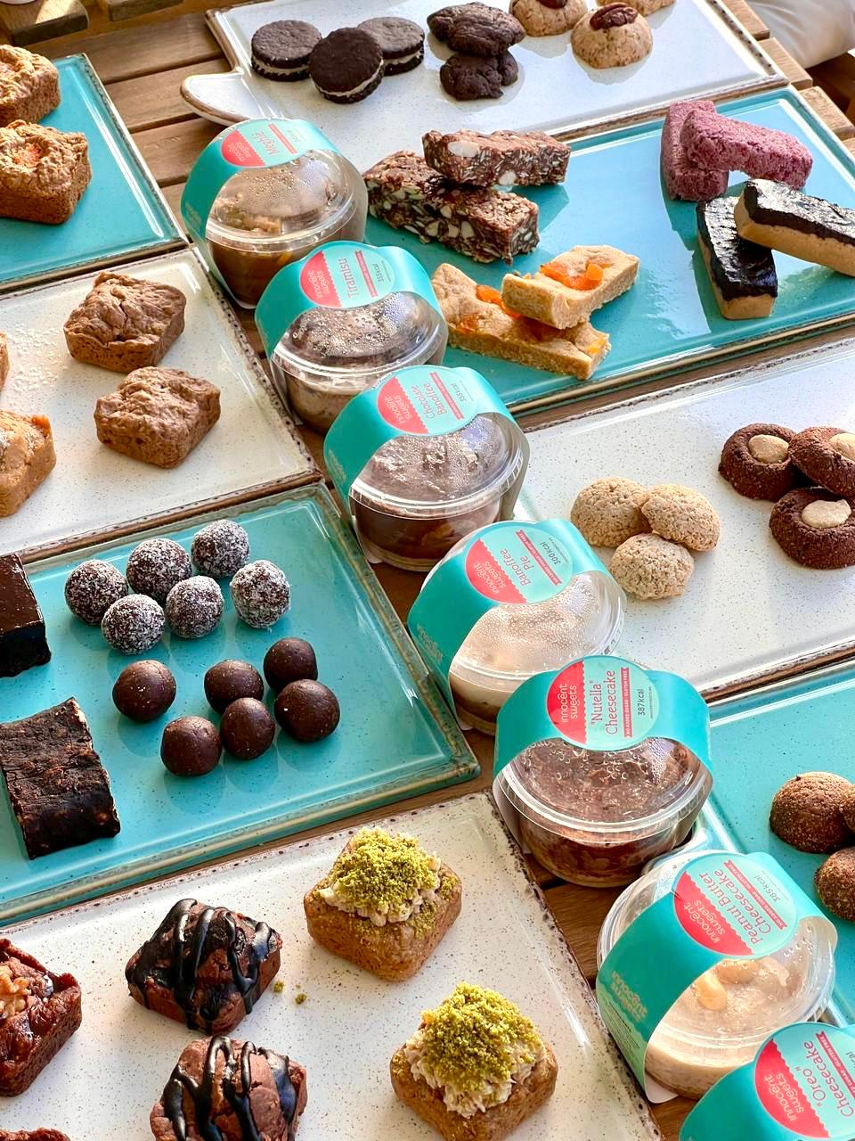 Assorted pastries and desserts on trays - Innocent Sweets - Gluten Free - Dairy Free - Refined Sugar Free