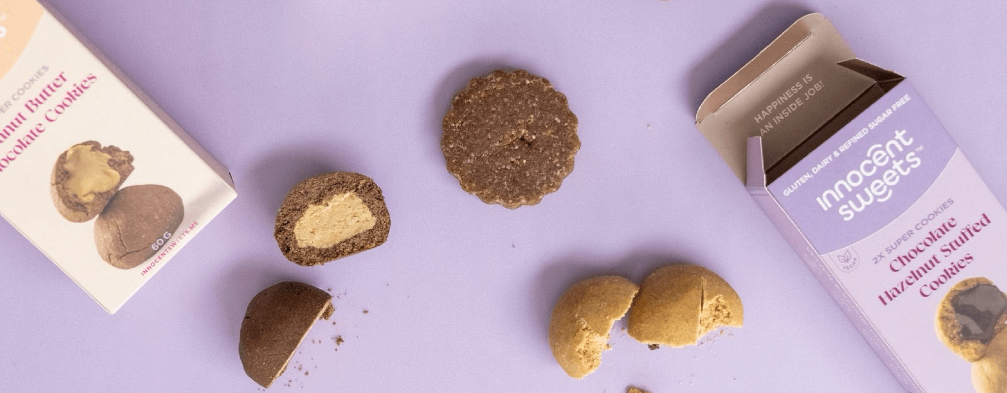 Innocent Sweets chocolate hazelnut cookies with packaging on a purple background
